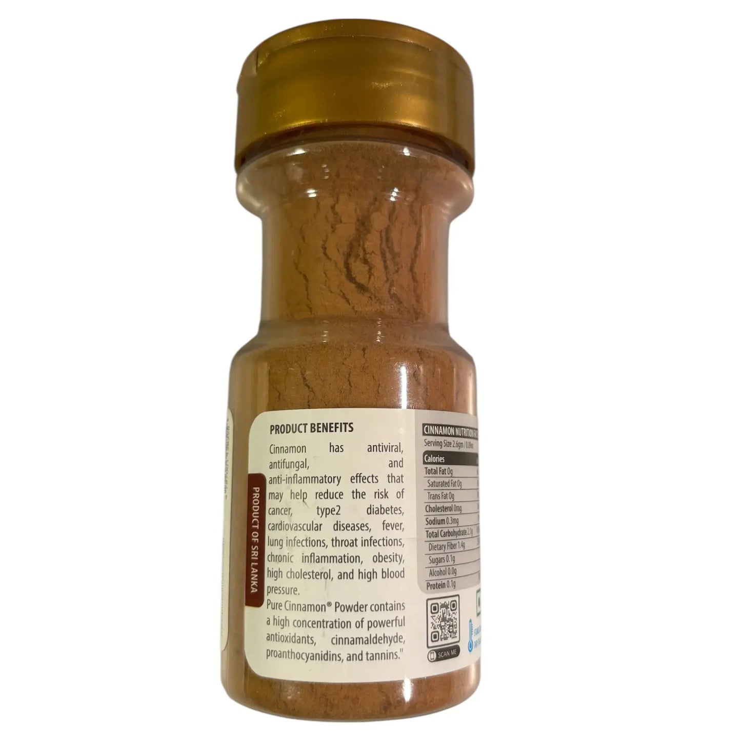 Bottle of cinnamon powder with gold lids on a white background