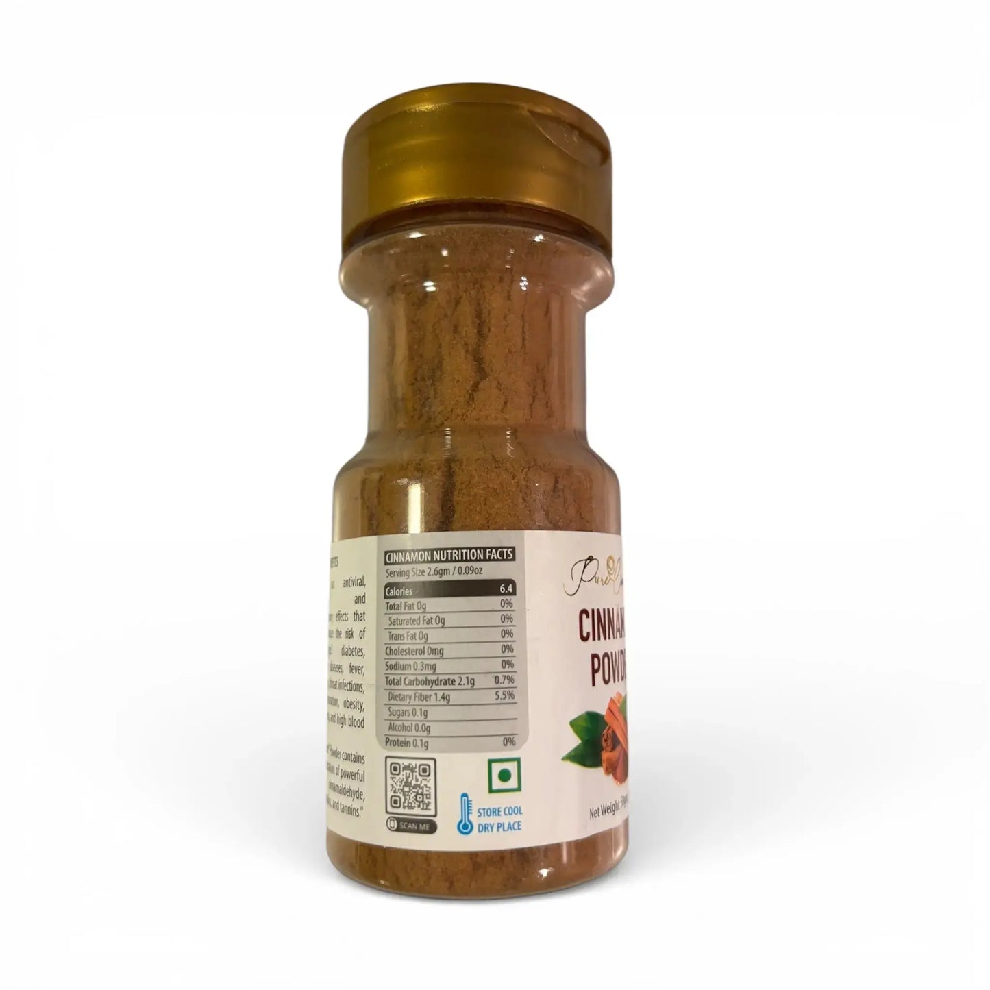 Bottle of cinnamon powder with a gold cap on a white background